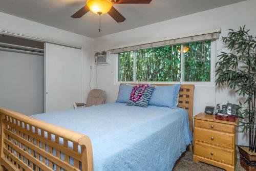 a bedroom with a bed and a ceiling fan at Mahalo in Honolulu