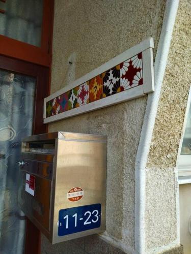 a parking meter on the side of a building at Private Room in Japanese Vintage House 民家の一室 2 Beds, Smoke Free, Free Parking Good to Travel for Tashiro Cats Island no2 in Ishinomaki