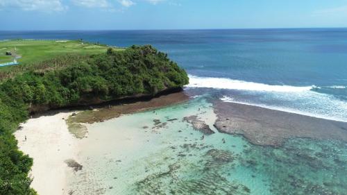 an aerial view of a beach and the ocean at La Reserva Villas Bali in Jimbaran