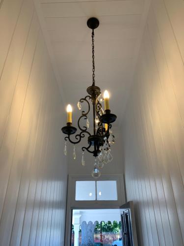 a chandelier hanging from a ceiling in a room at The Bank House Ulmarra in Ulmarra