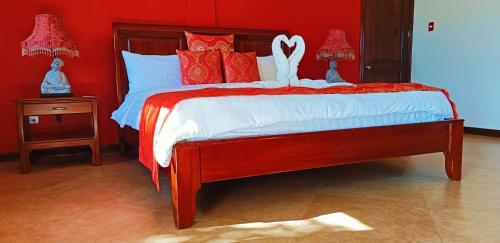 a red bedroom with a bed with a red wall at Star View Boutique Resort in Dumaguete