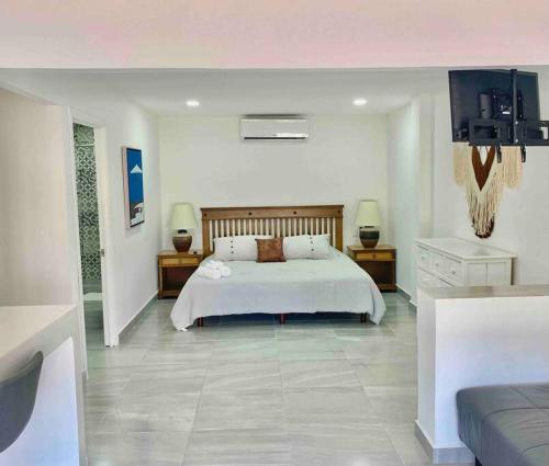 a bedroom with a bed and a television in it at 5th Av Studio Close to the Beach ADO Ferry & Mall in Playa del Carmen