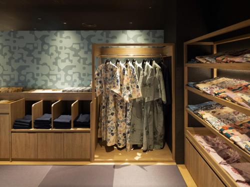 a walk in closet with clothes on display at Hotel Sakura Ureshino in Ureshino