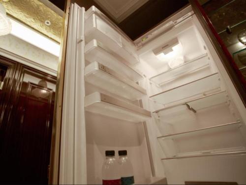 two bottles of water are sitting inside of an empty refrigerator at Gangnam Artnouveau City in Seoul