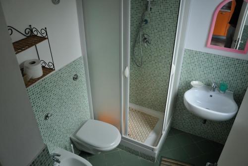 a bathroom with a shower and a toilet and a sink at Casa Blu in Linosa