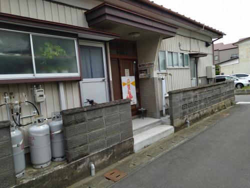 a house with two gas tanks outside of it at 民家の一室1 Private Room in Japanese Vintage House with Tatami, Single Bed, Free Parking, Good to Travel for Tashiro Cats Island in Ishinomaki