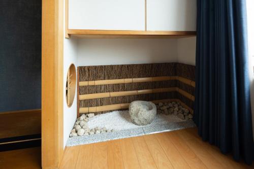 a corner of a room with a rock in a closet at Hotel Sakura Ureshino in Ureshino