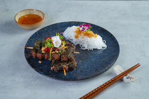 a plate of food with rice and meat on it at The Oriental Jade Hotel in Hanoi