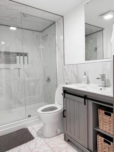 a bathroom with a shower and a toilet and a sink at The Victoria Suite in Elora- King Bed in Elora
