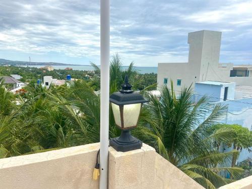 a street light sitting on the side of a wall at Kim Long Hotel in Phan Thiet