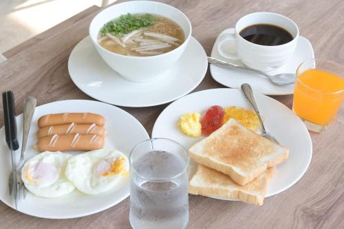 a table with plates of breakfast food and a cup of coffee at Baan Kieng Tawan in Khong Chiam