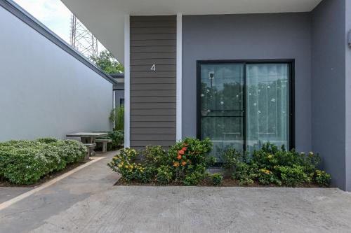 a house with a glass door and some flowers at Baan Kieng Tawan in Khong Chiam