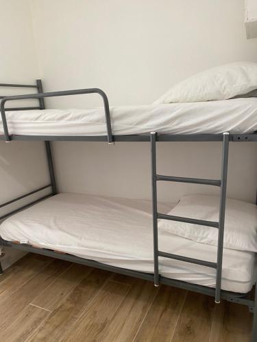 deux lits superposés dans une chambre avec parquet dans l'établissement Little garden, à Saint-Cyr-sur-Mer