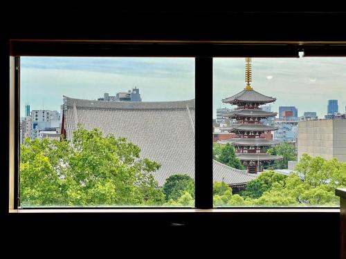 a view of a city from a window at TenTen Guesthouse in Asakusa in Tokyo
