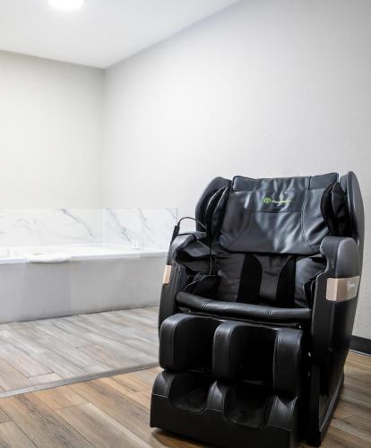 a black leather reclining chair in a room at Days Inn by Wyndham Augusta Fort Eisenhower in Augusta