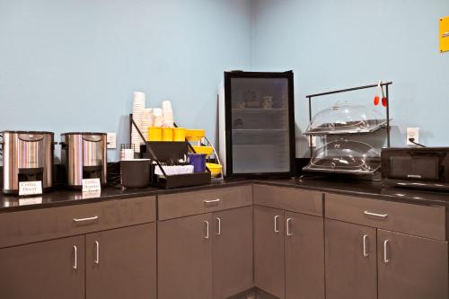 a kitchen with a counter with many items on it at Days Inn by Wyndham Augusta Fort Eisenhower in Augusta
