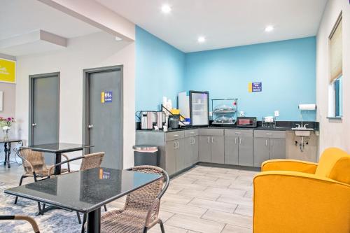 a waiting room with a table and chairs at Days Inn by Wyndham Augusta Fort Eisenhower in Augusta