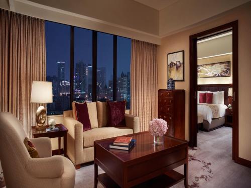 a living room with a bed and a large window at The Portman Ritz-Carlton Shanghai in Shanghai
