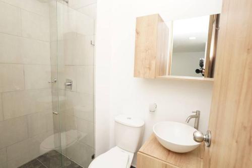 a bathroom with a toilet and a sink and a shower at Apartamento Medellin-sabaneta a cuadra del metro in Sabaneta