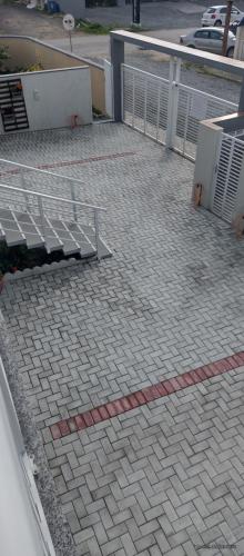 a bench sitting on a sidewalk next to a fence at Apart ZSS in Penha