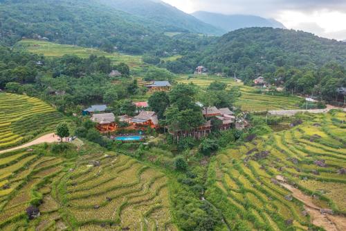 an aerial view of a house in the middle of a field at Puluong Valley Home in Pu Luong