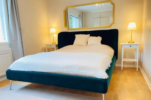 a bedroom with a bed with a mirror on the wall at Beautiful 2 bedroom & Free parking in Turku
