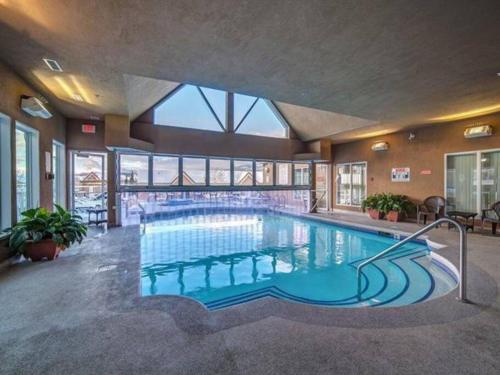 a large swimming pool in a large building at Downtown Kelowna 2 Bdrm 2 Bath Waterfront Condo in Kelowna