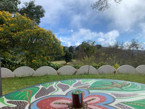 a table in front of a white picket fence at Cabaña Mamá Elia in Trinidad