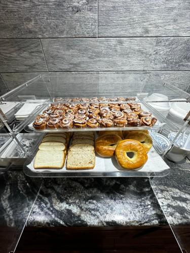 a bunch of donuts on trays on a table at Super 8 by Wyndham Eau Claire WI in Eau Claire