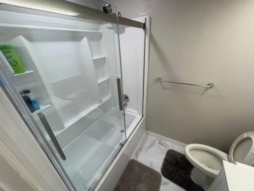 a bathroom with a shower stall with a toilet at Lakeside retreat - 3 Bedroom, 2 Bathroom house by the lake in Lakeland