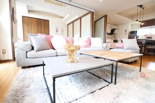 a living room with a couch and a table at NK BLD5F Sapporo 3LDK 3BR 1 floor 1 room in Sapporo