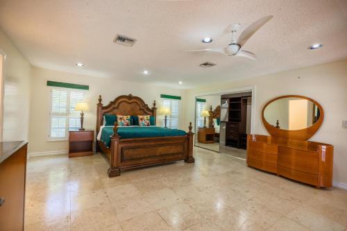 a large bedroom with a bed and a mirror at The Lakeview Retreat! So Much Room for Activities in Lauderhill