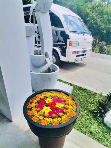 a flower pot with flowers in it next to a van at Shanti Wellness Sanctuary in Lemery