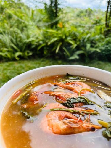 a bowl of soup with shrimp and vegetables in it at Shanti Wellness Sanctuary in Lemery