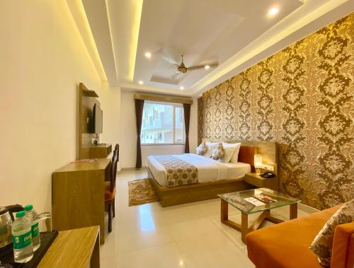 a hotel room with a bed and a living room at Arogyadham Wellness Retreat in Rishīkesh