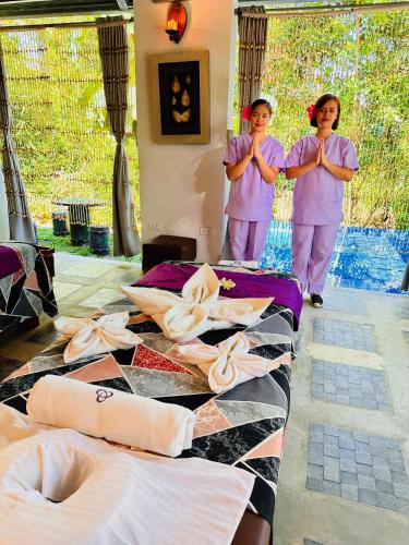 two women standing in a room with theirselves doing yoga at Shanti Wellness Sanctuary in Lemery