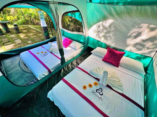a small tent with two beds in it at Shanti Wellness Sanctuary in Lemery
