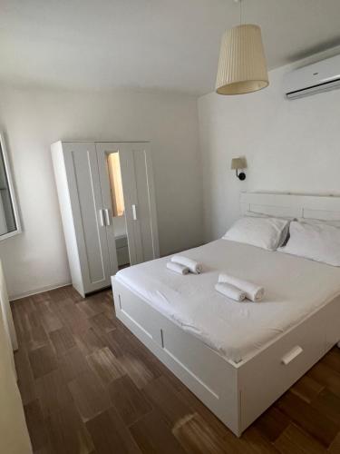 a bedroom with a white bed with two towels on it at Center, 15 minutes from Venice, Parking Miranese in Mestre