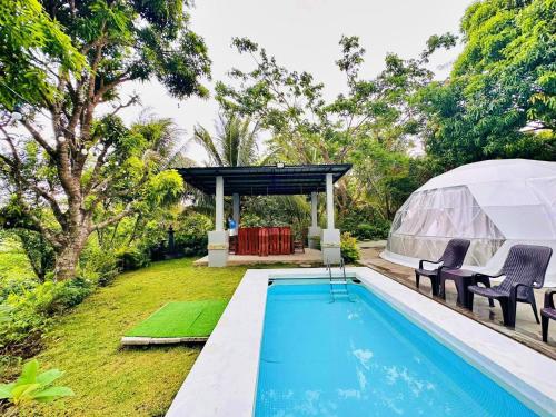 a luxury villa with a swimming pool and a marquee at Shanti Wellness Sanctuary in Lemery