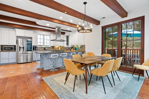 a kitchen and dining room with a table and chairs at Gorgeous Santa Cruz Villa - Modern Beachside Paradise with NEW Hot Tub & Fast Wi-Fi in Santa Cruz