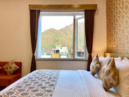 a bedroom with a bed and a large window at Arogyadham Wellness Retreat in Rishīkesh