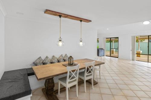 a dining room with a wooden table and chairs at FlipFlop Days in Dunsborough