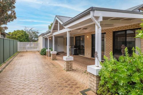 a house with a brick driveway in front of it at FlipFlop Days in Dunsborough