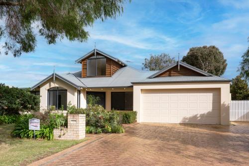 a house with a garage in front of it at FlipFlop Days in Dunsborough