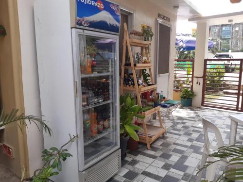 a refrigerator with drinks inside of a store at Sandstorm Lodge and Cafe in Puerto Galera