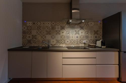a kitchen with a sink and a counter top at La casa del Vescovo in Imola