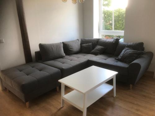 a living room with a couch and a table at Ferienwohnung Storchennest in Drochtersen