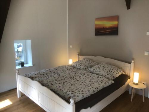 a bedroom with a bed with two candles on it at Ferienwohnung Storchennest in Drochtersen