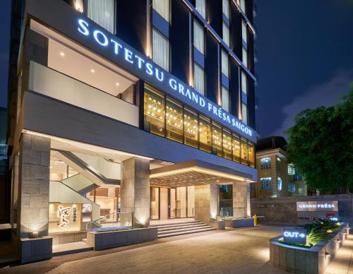 a building with a sign on the side of it at Sotetsu Grand Fresa Saigon in Ho Chi Minh City