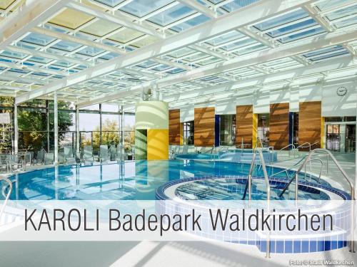 a large building with a pool in the middle at Hütte40: Ganze Hütte nah am See mit privatem Whirlpool, Sauna. Umzäunt. in Waldkirchen